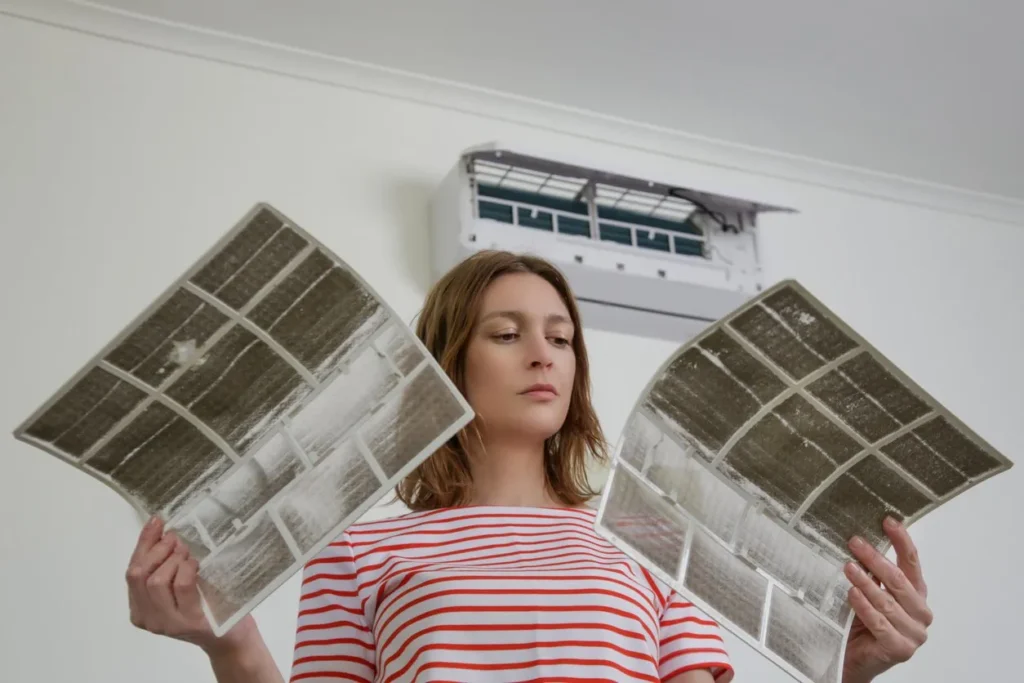 Womanholdingverydirtyairconditionerfiltersstockphoto 8b6a3104 1920w